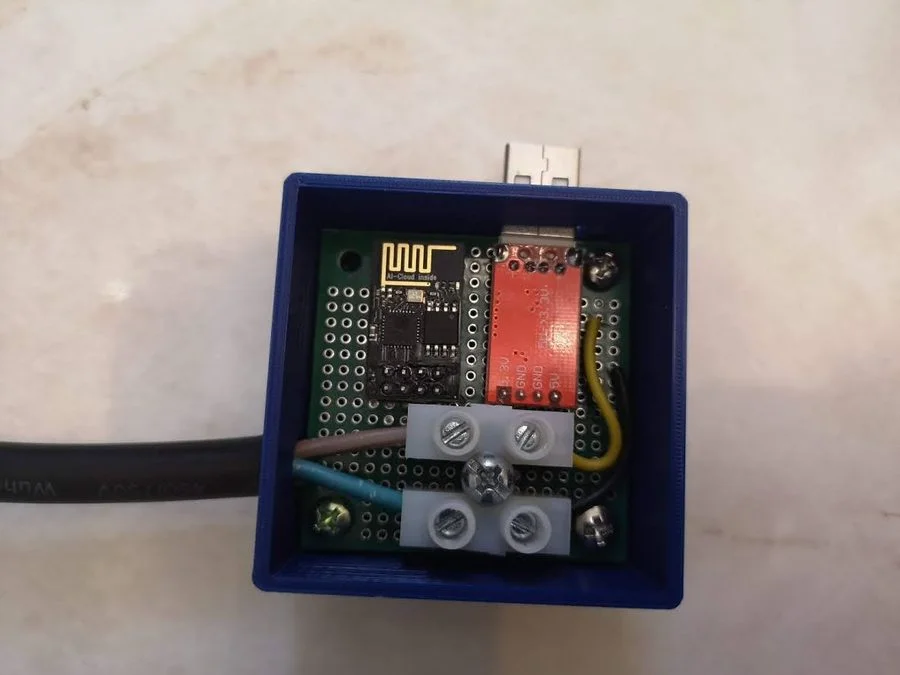 Inside the DIY septic alarm enclosure showing WiFi module, power supply and terminal blocks